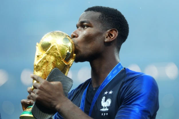 MOSCOW, RUSSIA - JULY 15: Paul Pogba of France celebrates victory by kissing the World Cup trophy following the 2018 FIFA World Cup Final between France and Croatia at Luzhniki Stadium on July 15, 2018 in Moscow, Russia. (Photo by Lars Baron - FIFA/FIFA via Getty Images)